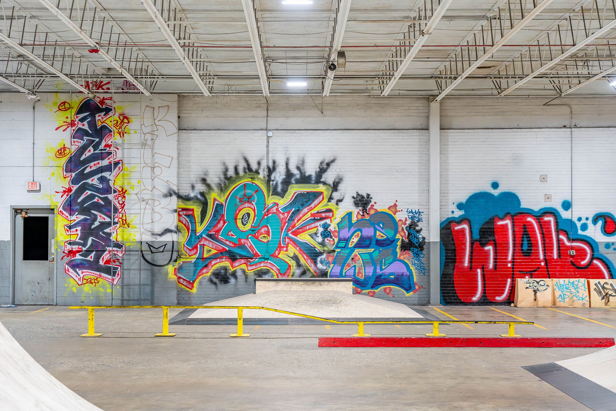 Graffiti art on a wall inside a warehouse.