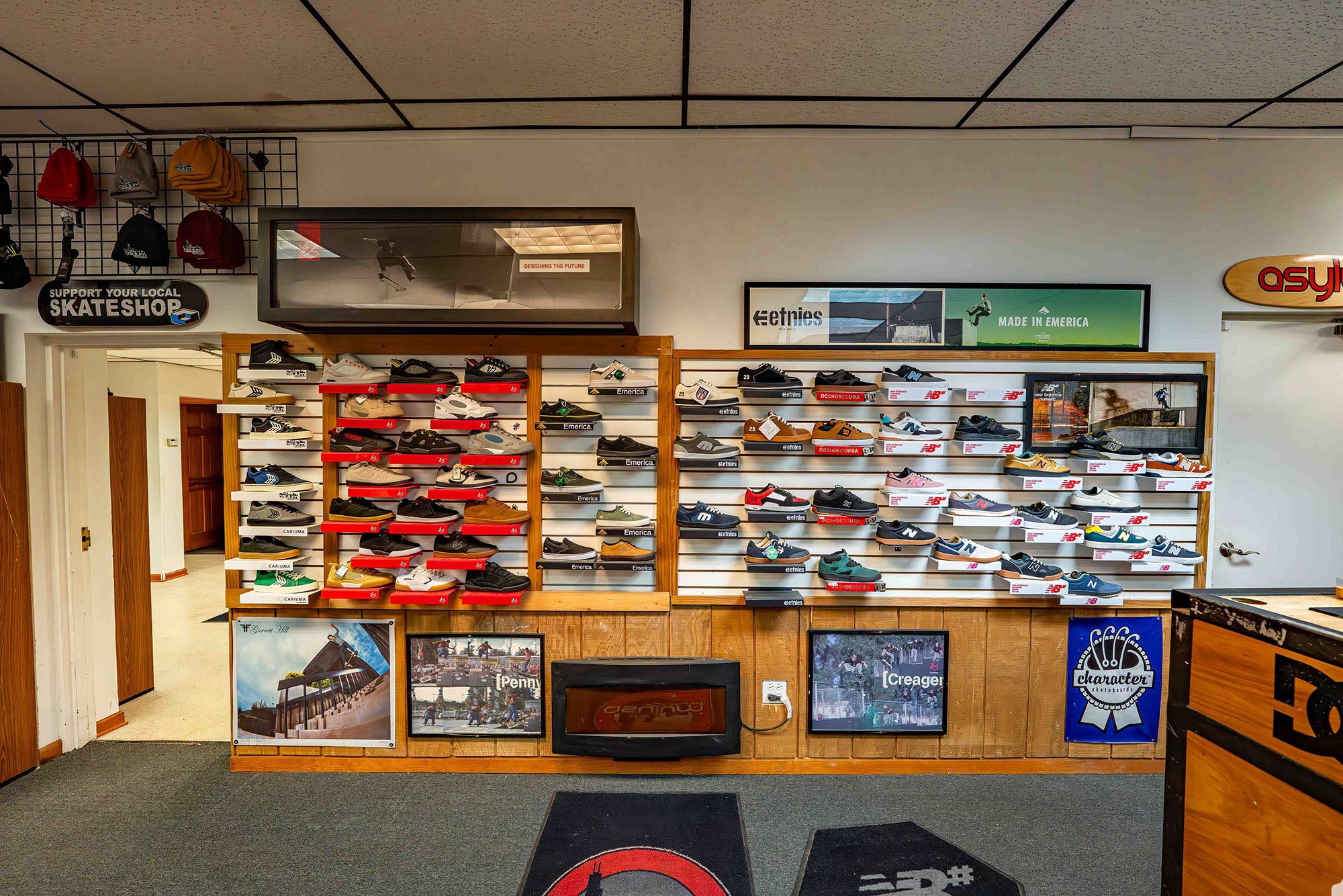 Shoe display case with various shoes in a store setting