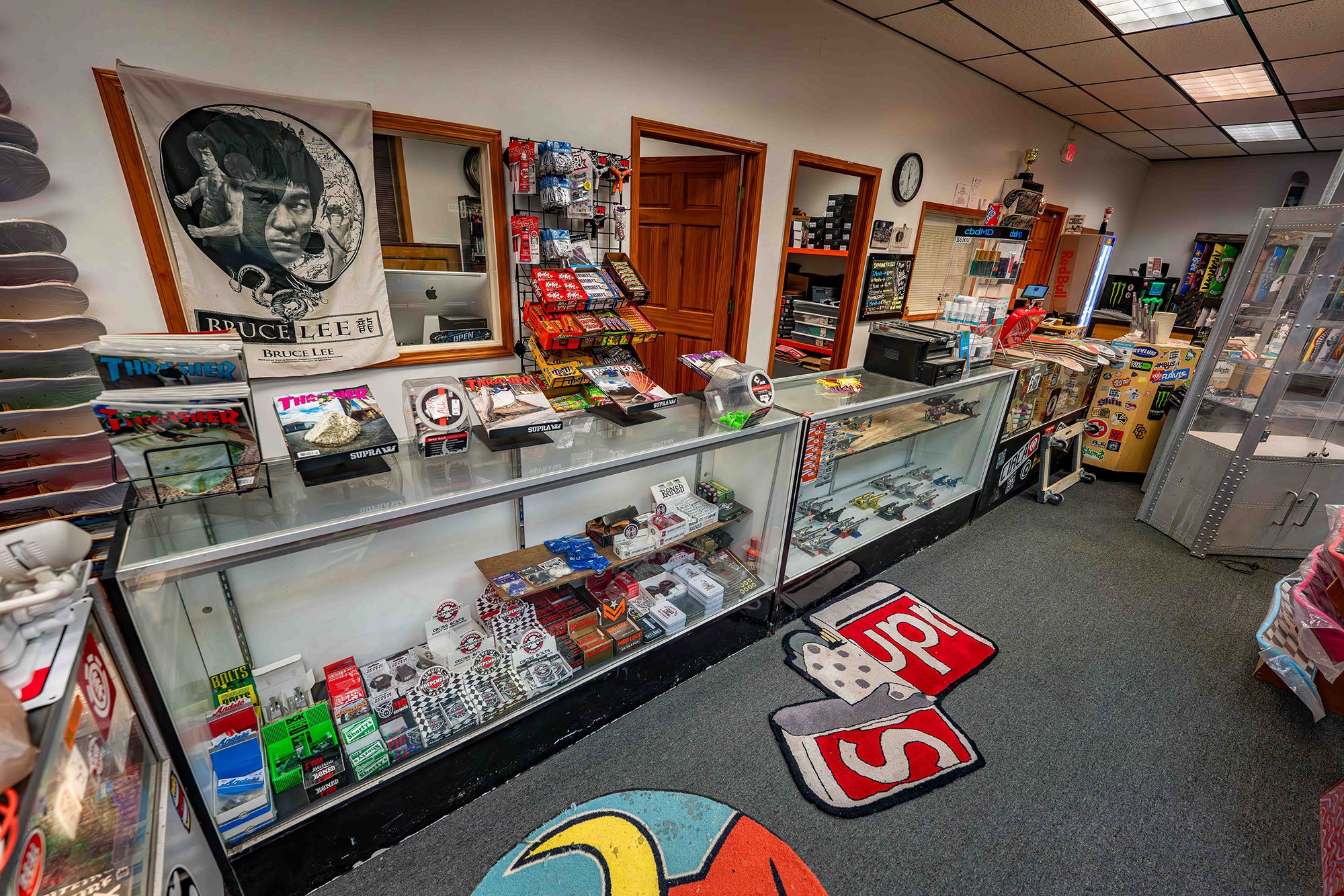 Store interior with display cases and various items on shelves.
