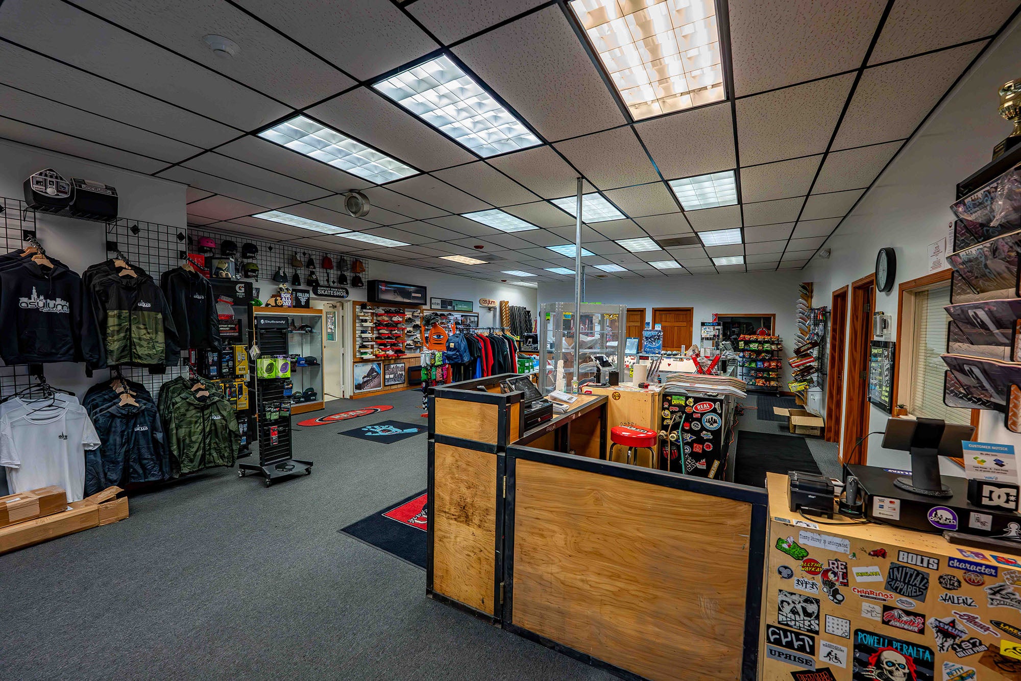 Interior of a store with various products on shelves and display racks.