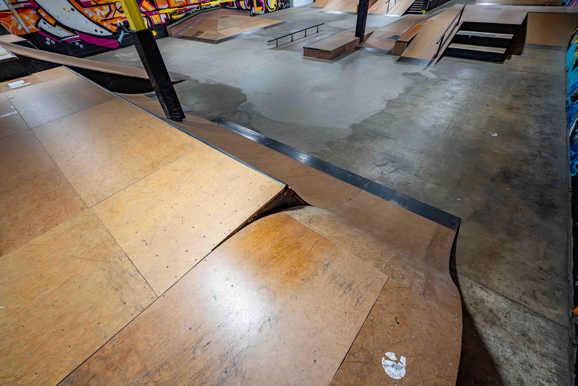 Skate park with wooden ramps and concrete surface